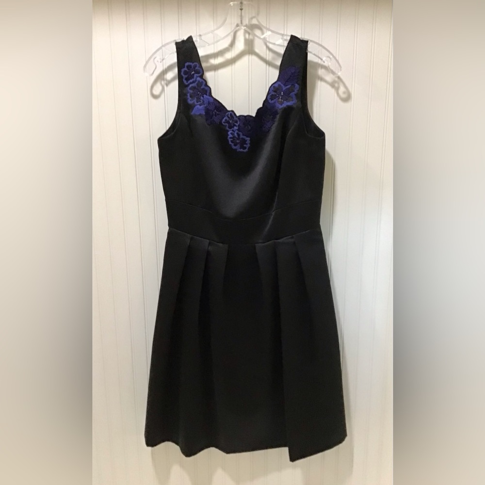 Black cocktail dress with floral trim on the neckline